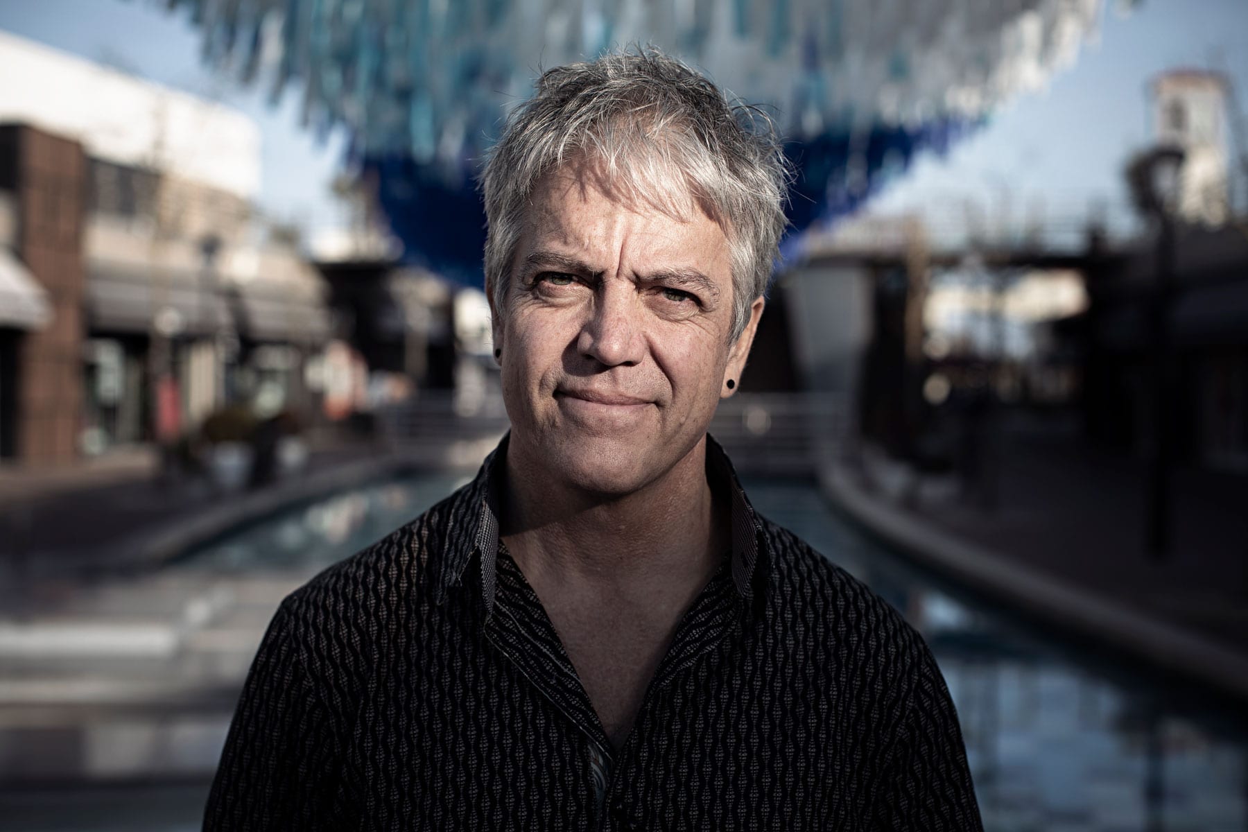 Patrick Shearn of Poetic Kinetics standing in front of Dream Waves from his Signature Skynet Art Series